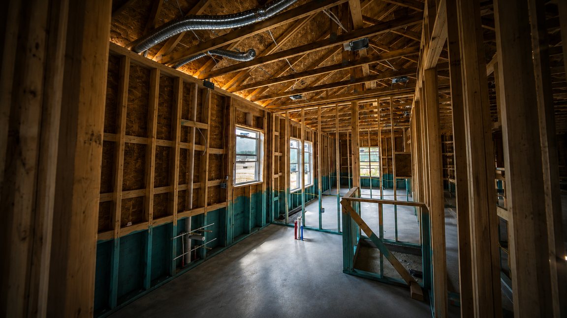 Framing, ductwork, and rough-in exposed during a new-construction phase inspection in Northeast Florida
